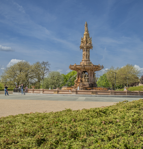 Sunny view of the large terracotta, five-tier, French Renaissance-style Doulton Fountain in Glasgow Green