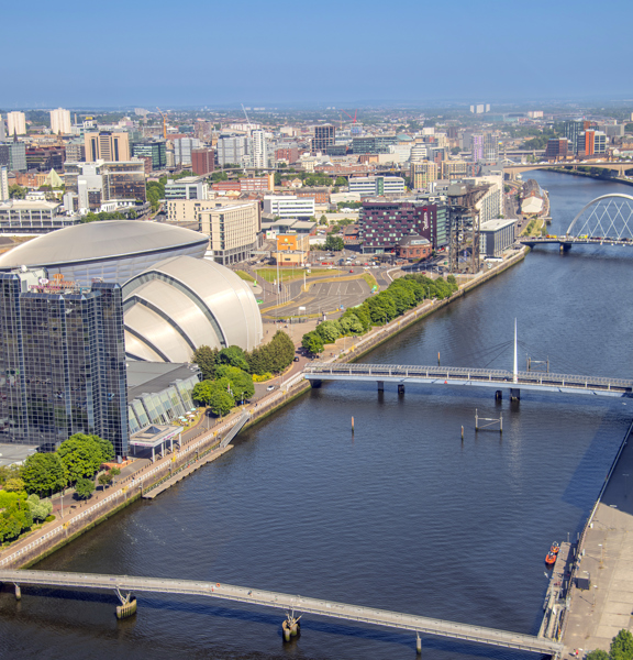 Aerial view of the River Clyde, with the Scottish Event Campus and glass tower of the Crowne Plaza hotel, with the city in the background