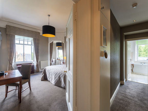 Picture taken from a doorway - bedroom to the left and and bathroom to the right