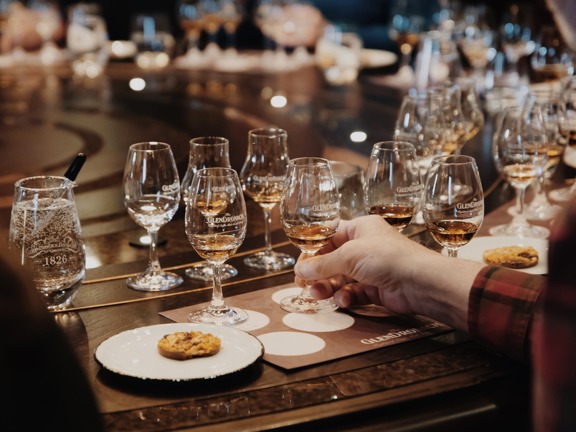 Large table set up with lots of whisky glasses for a tasting