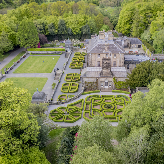 Aerial view of Georgian-style Pollok House with its manicured formal garden, set within the greenery of Pollok Country Park