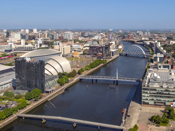 Aerial view of the River Clyde, with the Scottish Event Campus and the city on the left and the modern buildings of the BBC Scotland on the right.