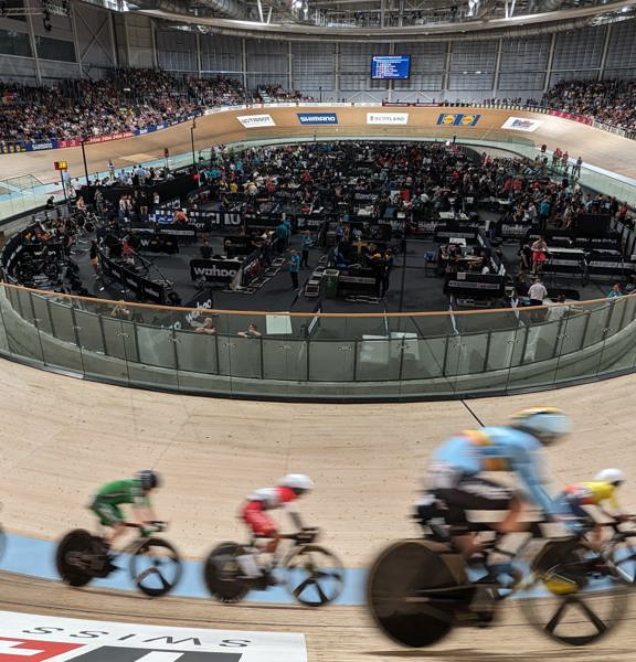 A group of cyclists race round the Sir Chris Hoy Velodrome.