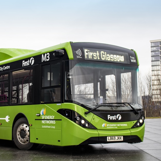 Green electric bus, with First Bus and SP Energy Networks signage
